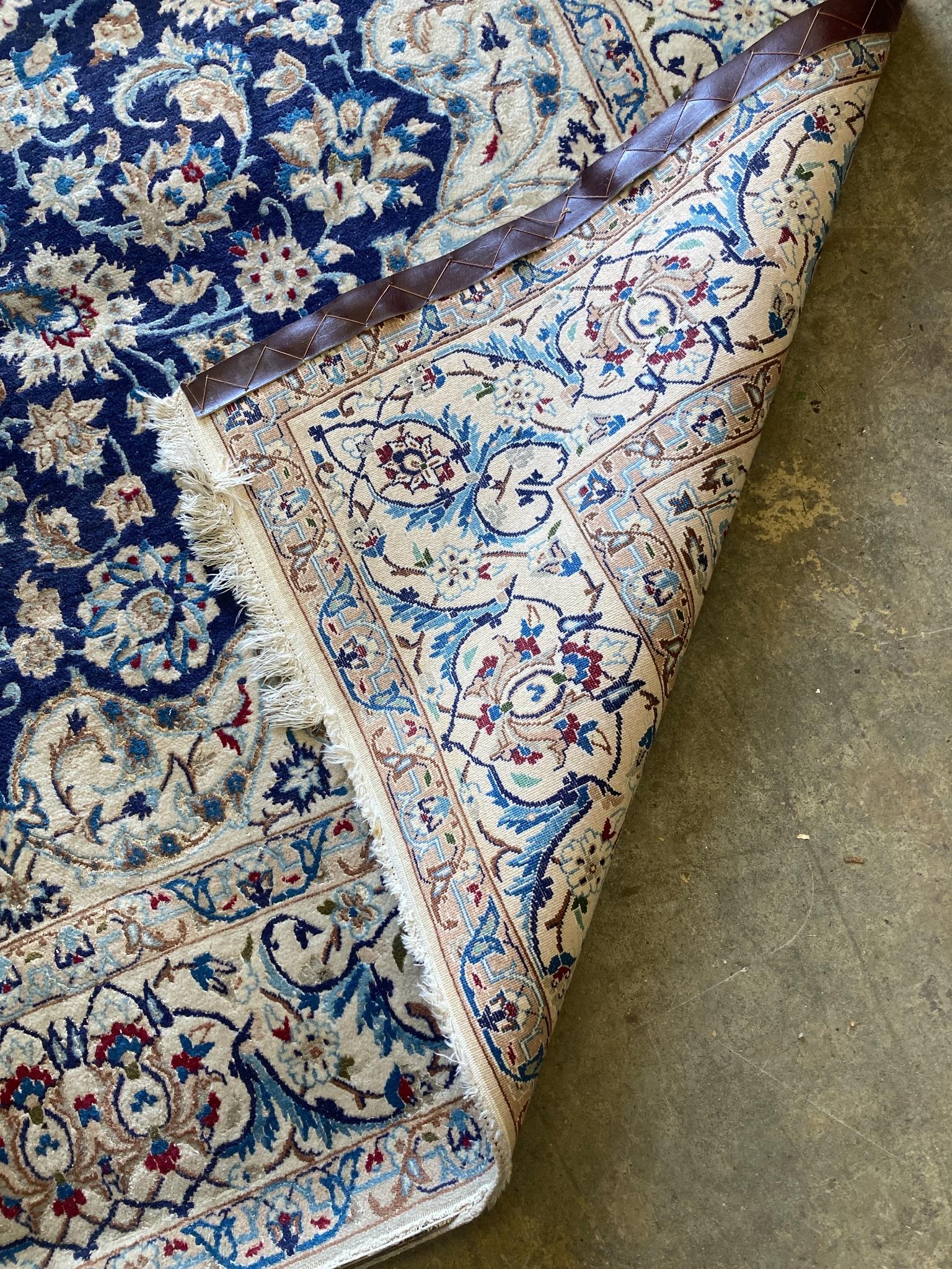 A North West Persian ivory ground carpet, 325 x 203cm